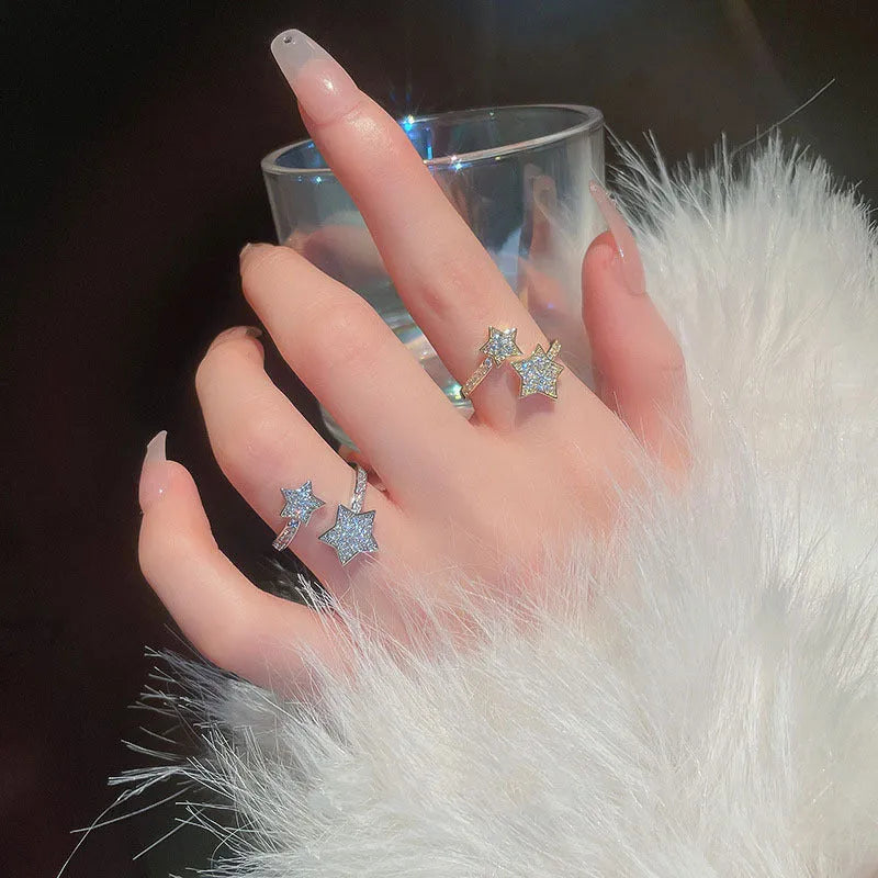 Gold cold style zircon star open-end ring and bracelet set on white background