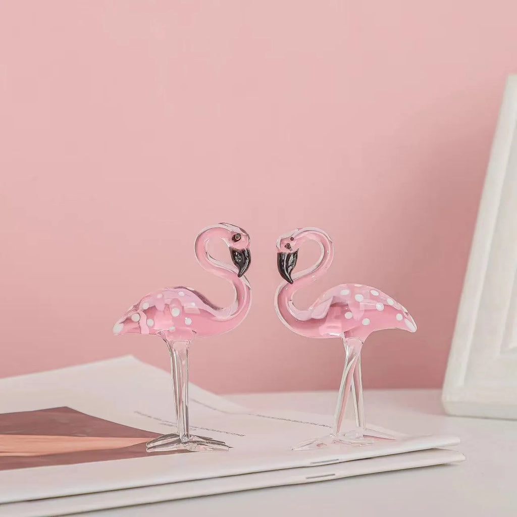 Pink crystal flamingo decorative ornament on a table for modern home decor.