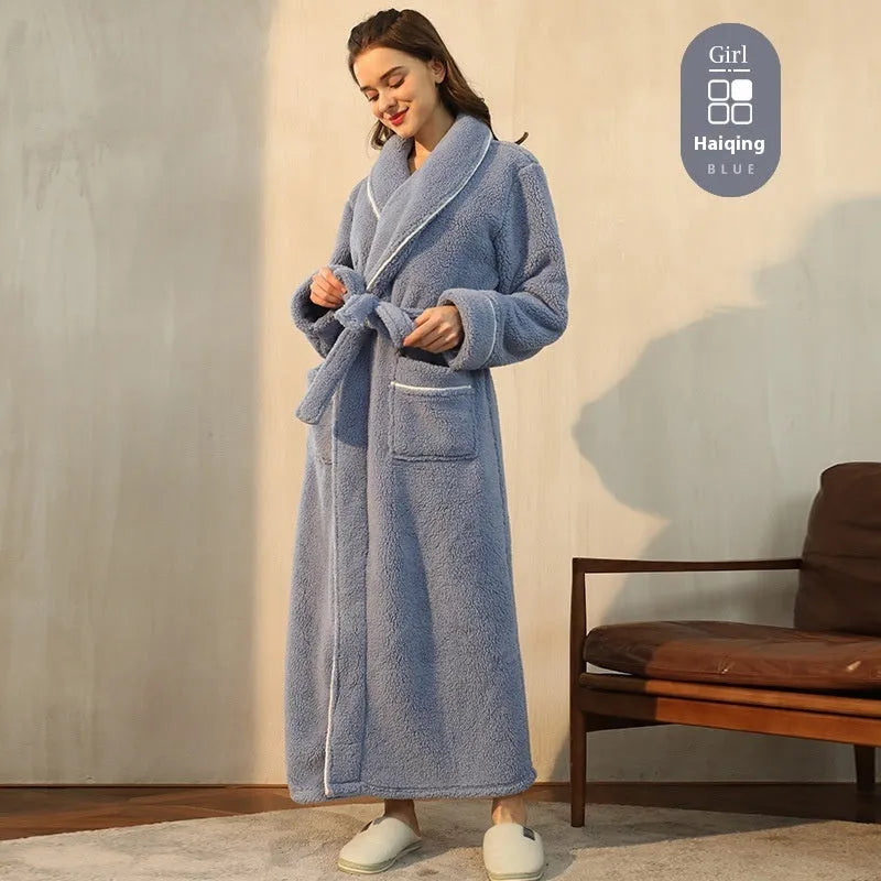 A man and woman wearing matching heavyweight navy blue flannel bathrobes, a couple's winter nightgown set.