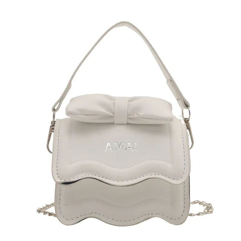 A women's mini crossbody bag in PU leather with an adjustable strap, shown in multiple colour options.