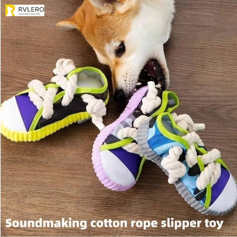 Grey and white dog toy slipper with black laces, blue sole, and a bell on the side