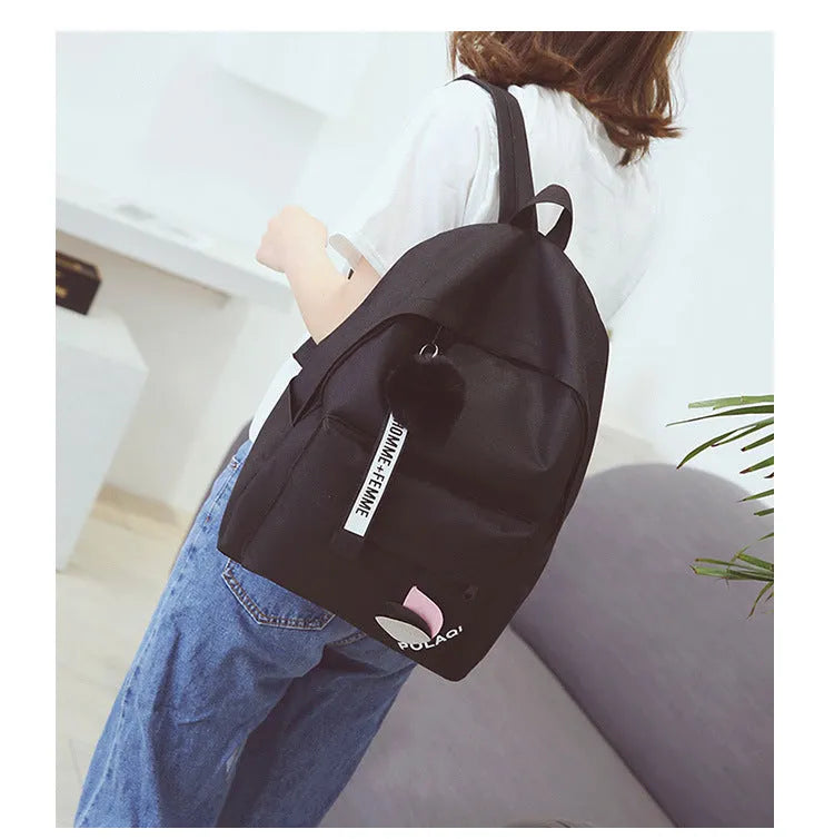 College style canvas backpack in green with leaf pattern, showing 40cm height and organisational compartments