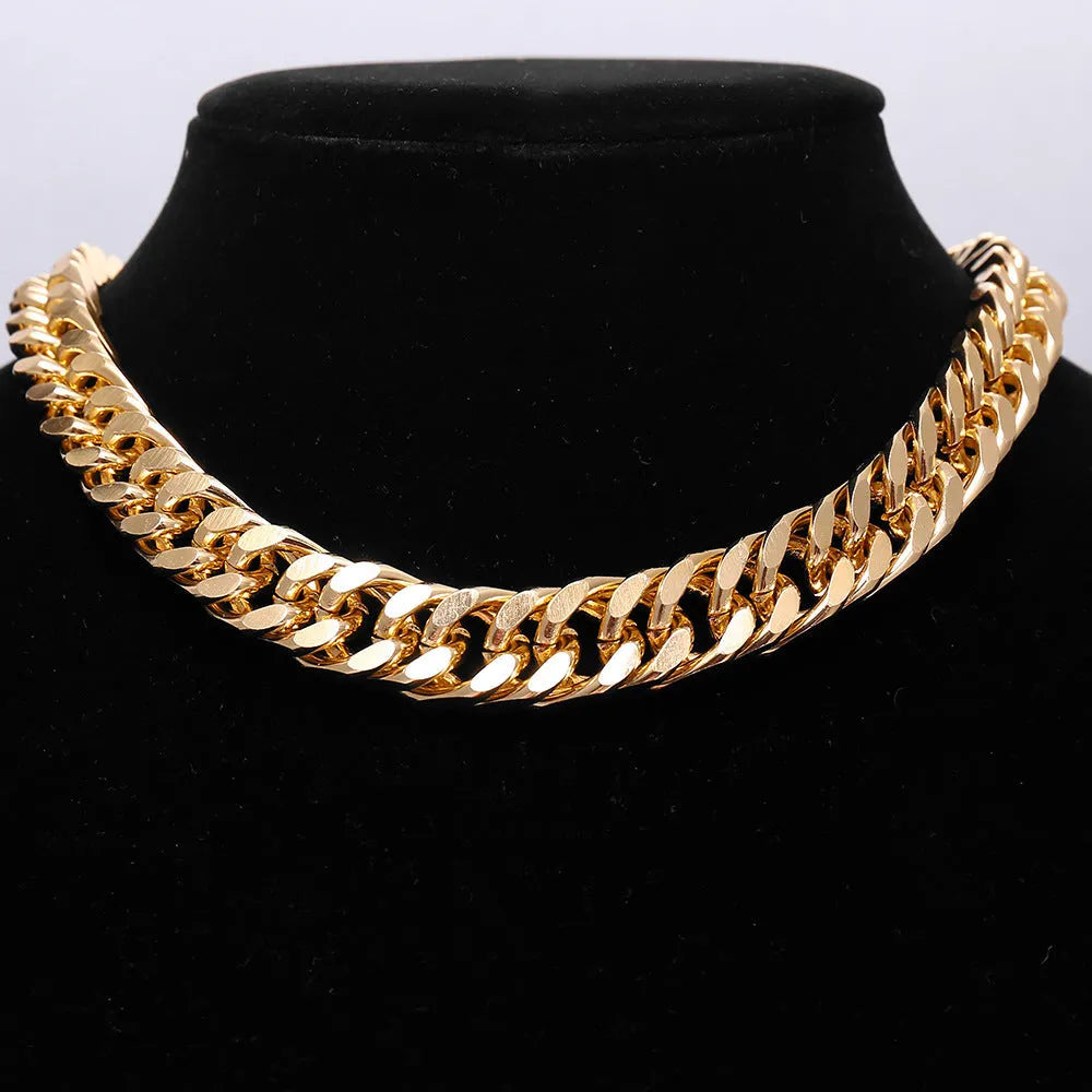 Gold-toned women's thick chain necklace with an integrated rectangular pendant, shown on a plain background.