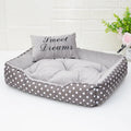 Polka dot print cloth dog bed with matching square pillow for small dogs, shown in grey colour.