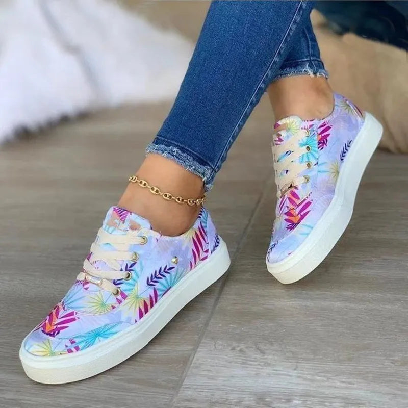 Light blue women's canvas lace-up flats with graffiti leaf print and round toe