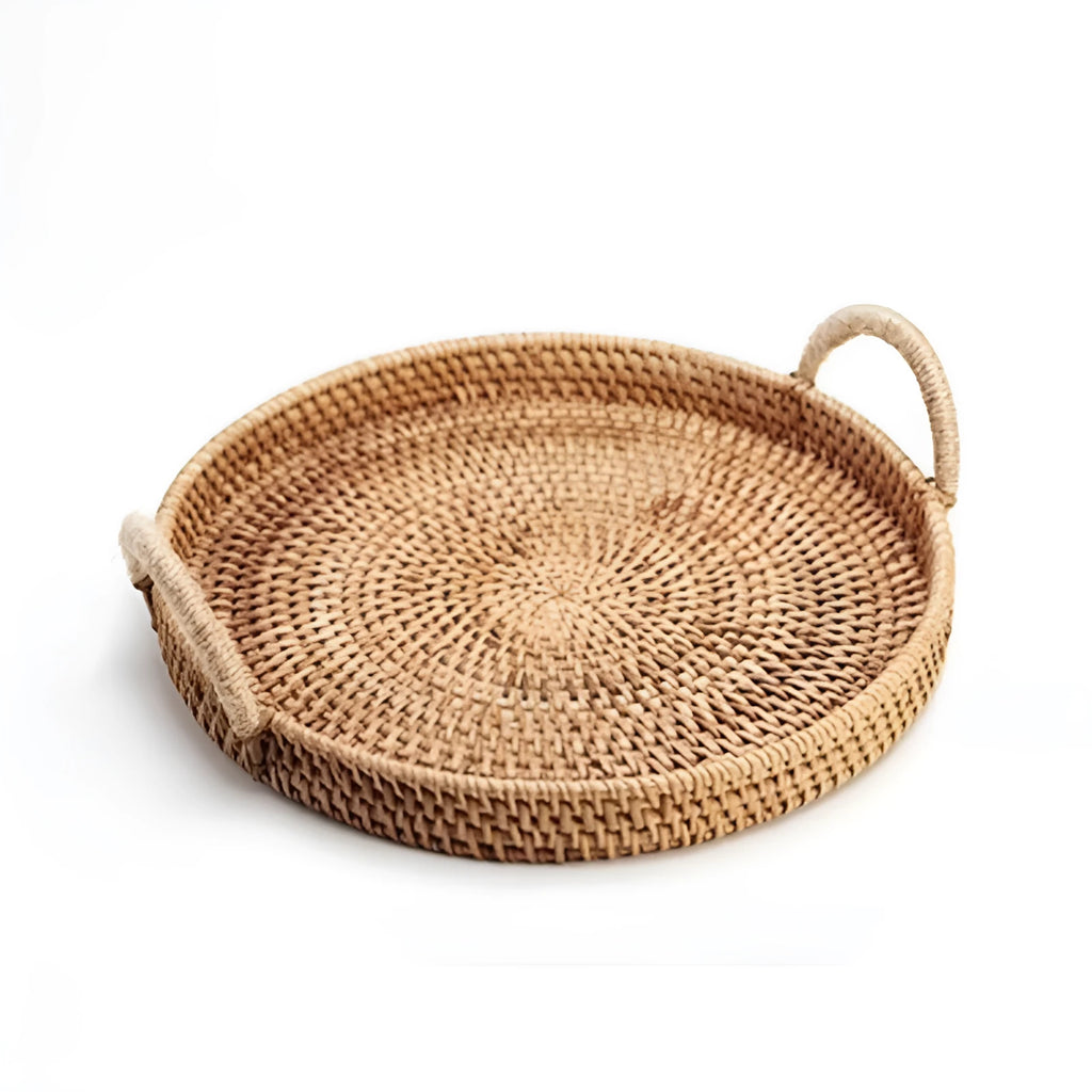 Round handwoven rattan storage basket with a light wooden handle on a table.