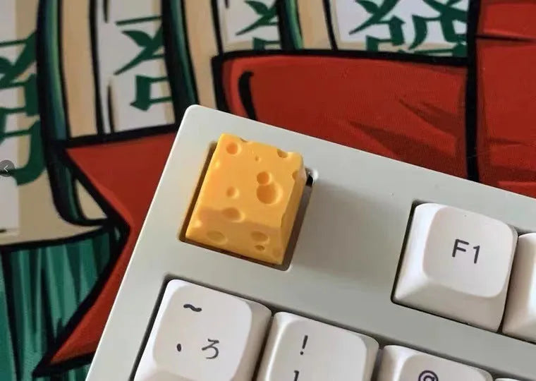 Yellow solid resin artisan key cap sculpted like a piece of cheese for mechanical keyboards.