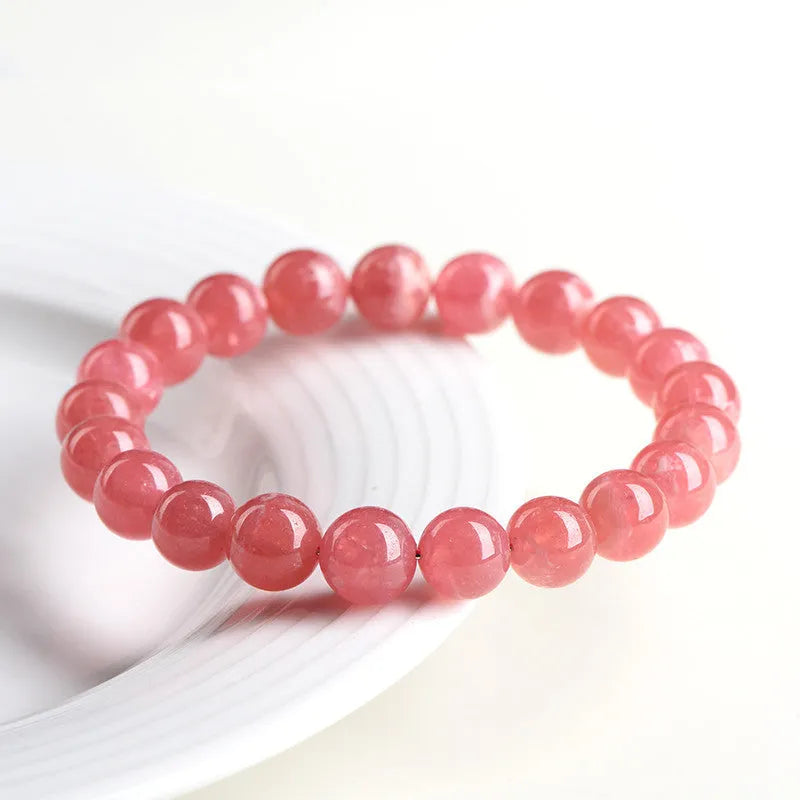 Women's geometric red rhodochrosite crystal bracelet with a longevity lock on a white background.