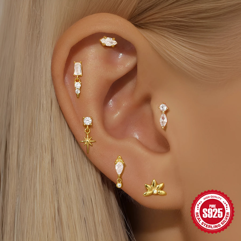 S925 sterling silver ear stud with XINGX inlaid tassel design in a gold colour.