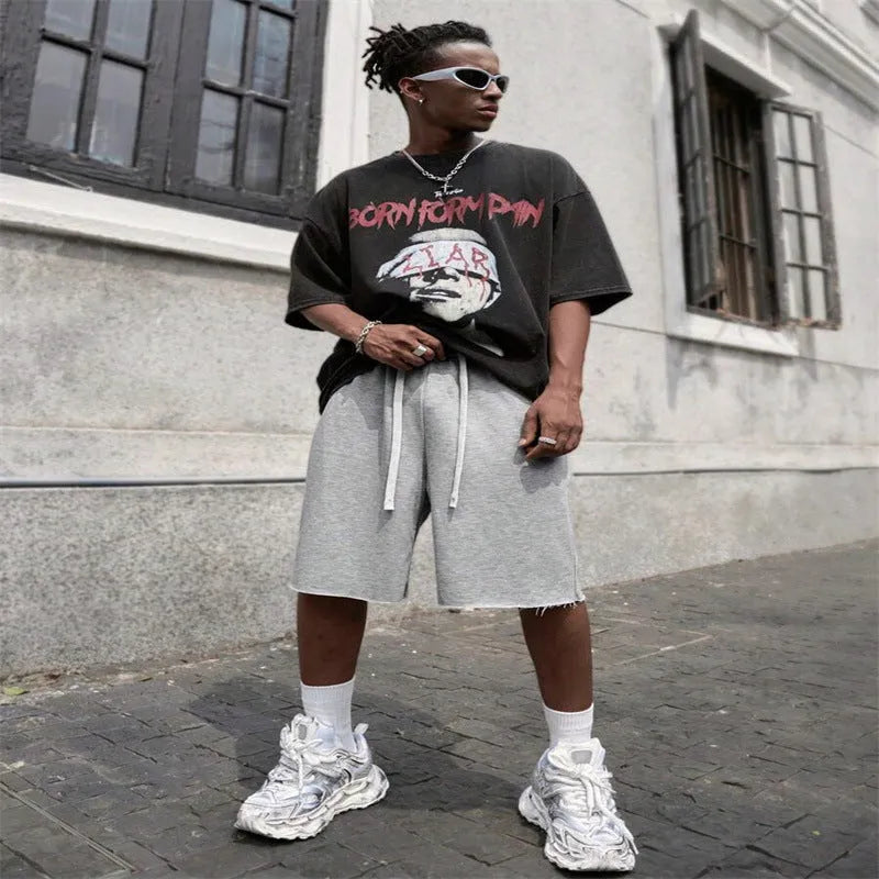 Men's black straight-leg hip-hop trousers in a medium length, laid flat.