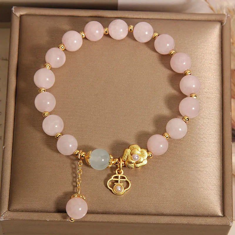 Women's pink crystal flower bracelet with detailed floral bead design on wrist