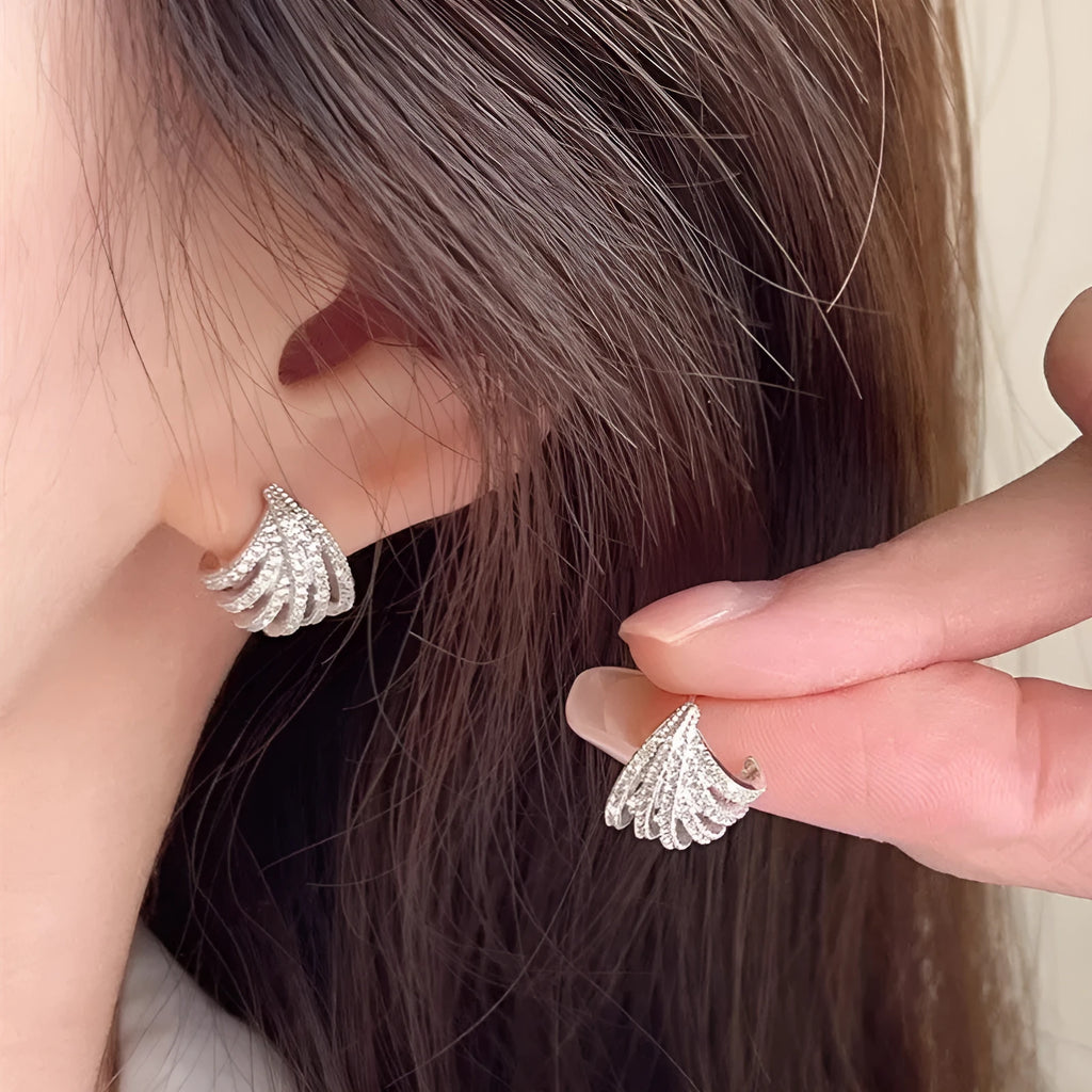 Geometric platinum-coloured zircon earrings for women on a white background.