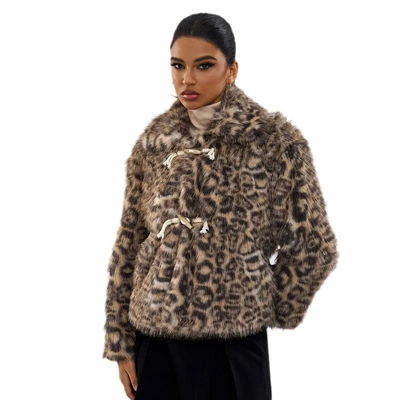 Women's leopard print coat with a buckle on the lapel collar, shown in street fashion style.