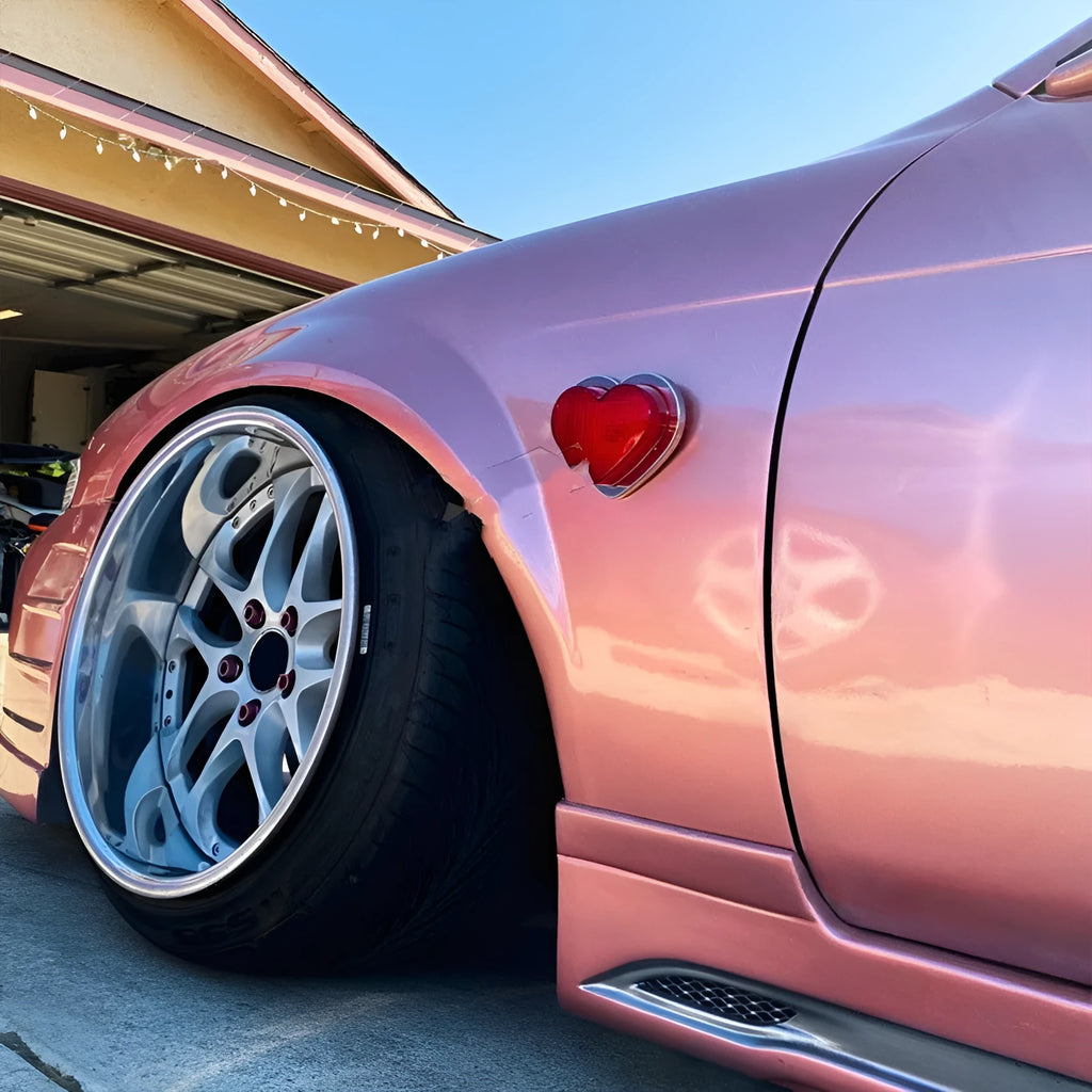 Heart-shaped red LED automotive sidelight mounted on car fender