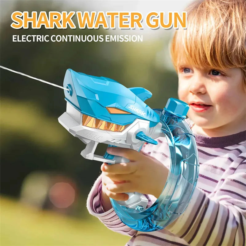 Blue Shark-shaped electric water gun toy with large tank on a sandy beach