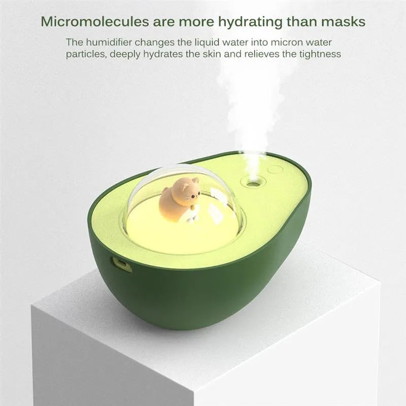 Green avocado-shaped mini humidifier with USB cable and night light on a desk