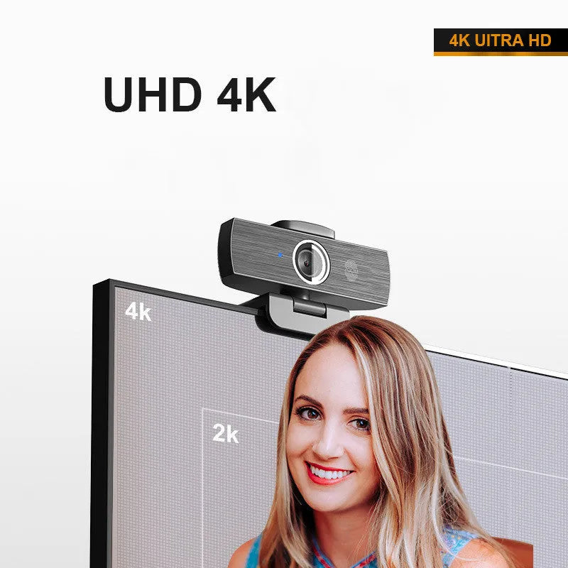 Black USB computer webcam with a magnetic privacy cover on a desk.
