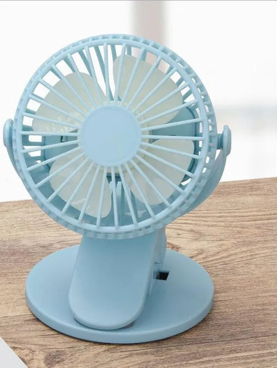 White portable clip fan with USB charging cable attached to stroller frame