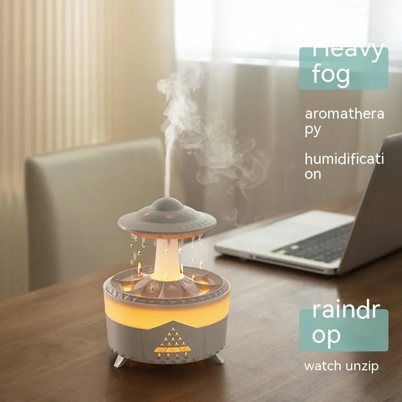 UFO cloud-shaped humidifier with LED lights and water droplet effects on dark surface