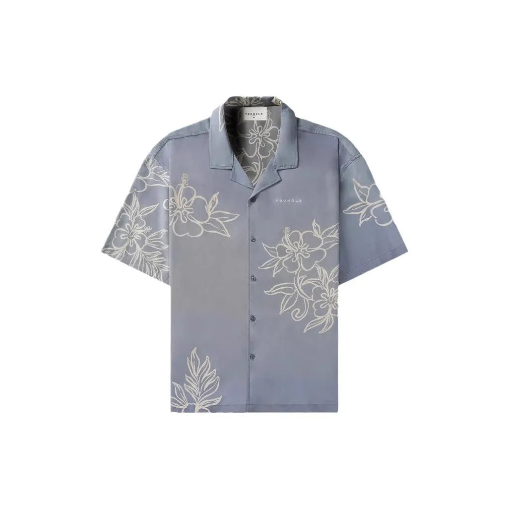 Man wearing a loose-fitting, short-sleeved printed top with a floral pattern in a neutral colour