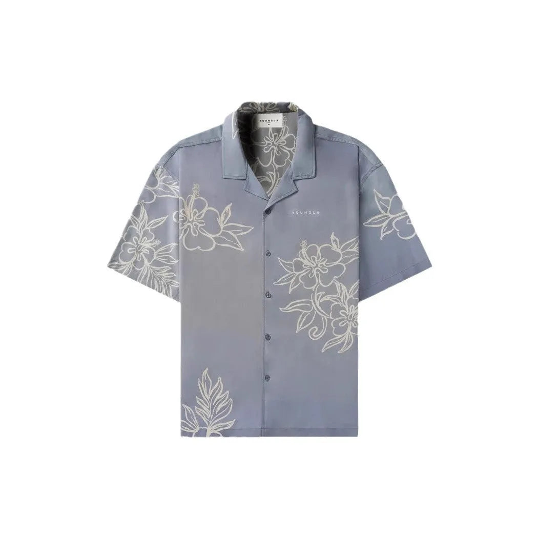 Man wearing a loose-fitting, short-sleeved printed top with a floral pattern in a neutral colour