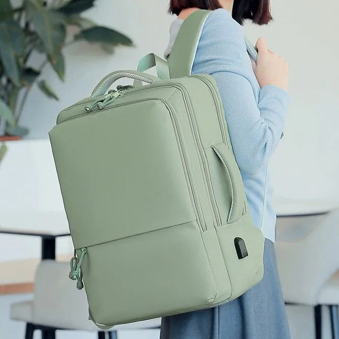 Green waterproof Oxford cloth backpack for business travel with air pillow straps, 45cm tall.