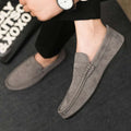 Men's black slip-on shoes with round toe, grape particle detail, and rubber sole.