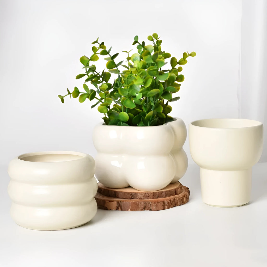 Roman column matte yellow ceramic flower pot on a table.
