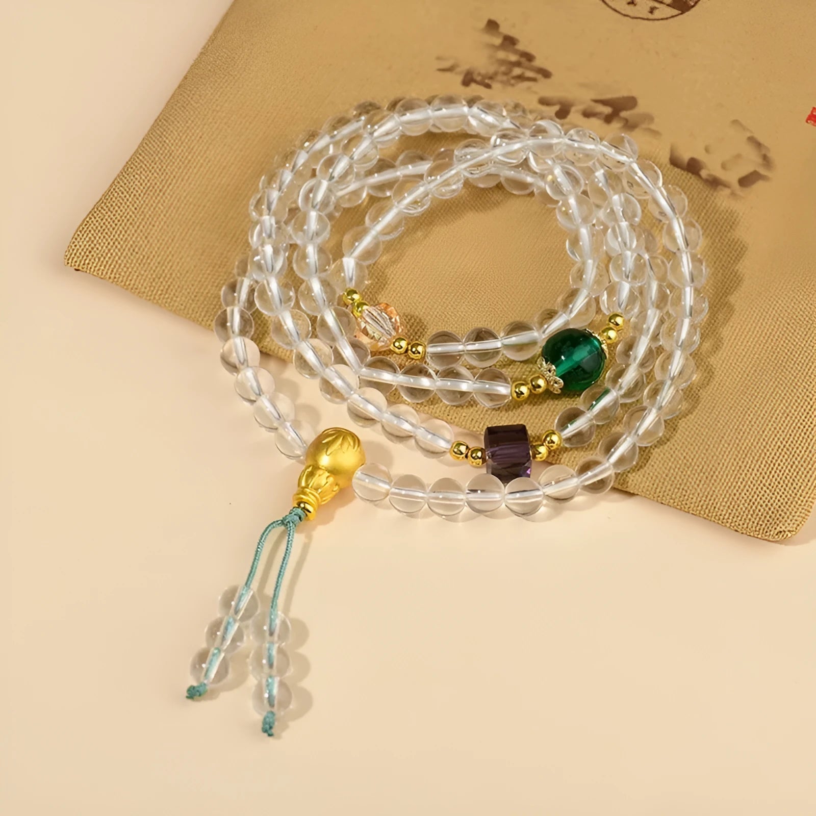 White crystal 108-bead rosary necklace and matching bracelet set on a plain background
