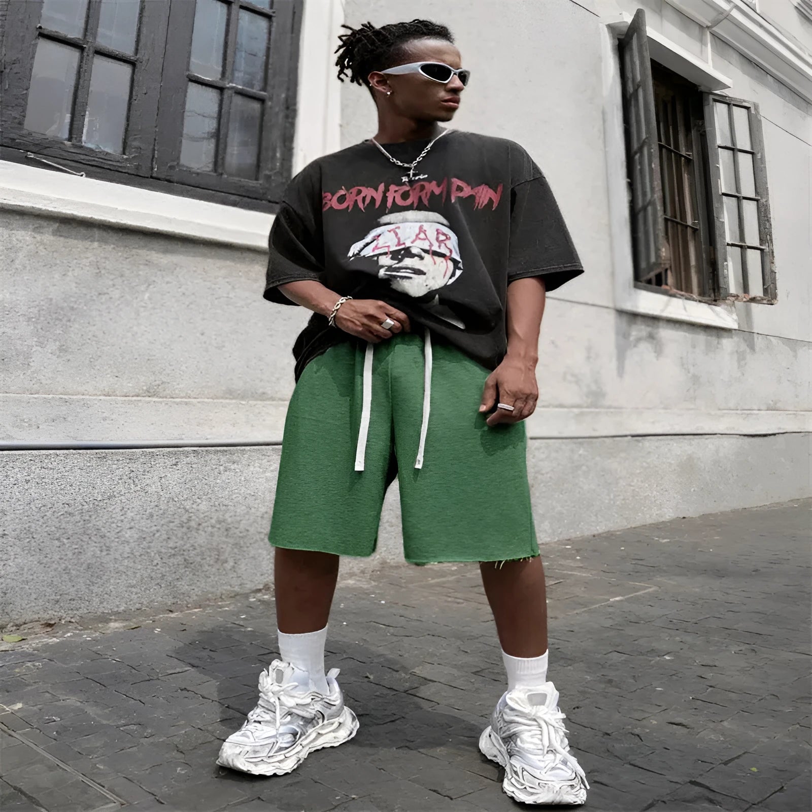Men's black straight-leg hip-hop trousers in a medium length, laid flat.