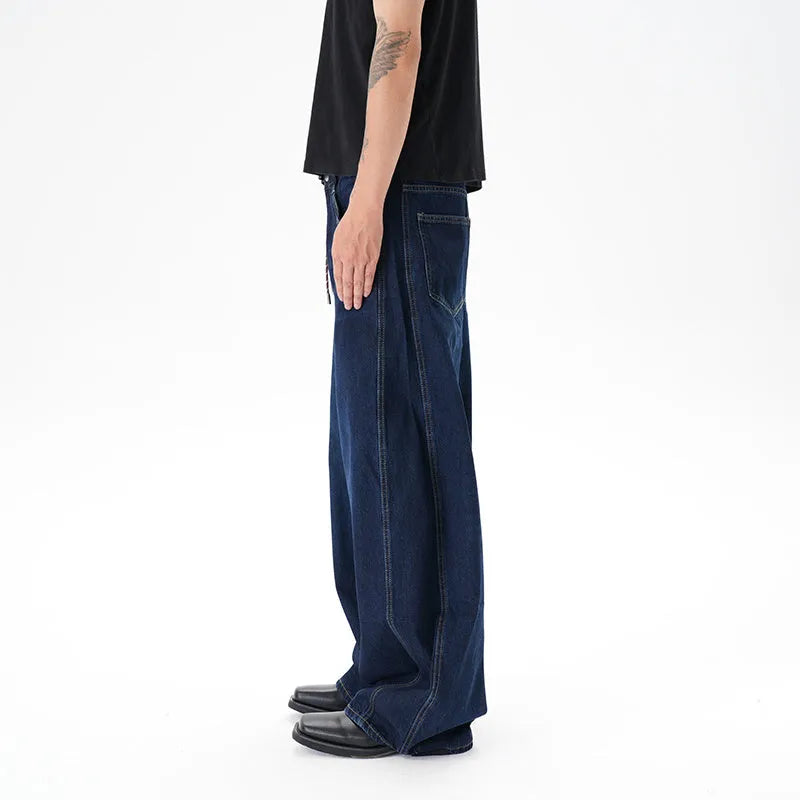 Dark blue washed distressed wide leg machete jeans showing denim fabric texture and wide leg silhouette