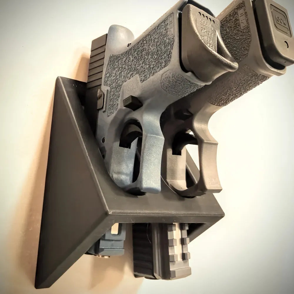 Black plastic punk-style pistol display stand for toy guns.