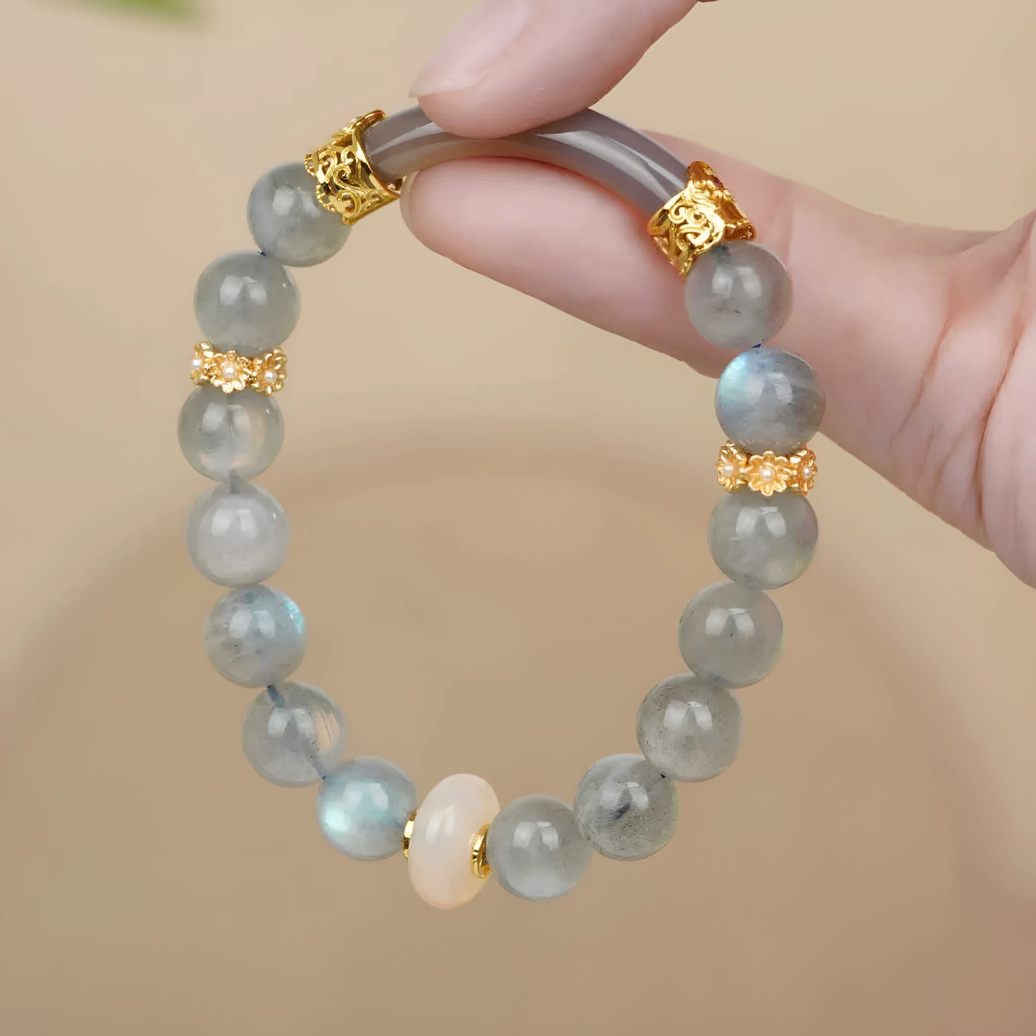 A simple gray moonstone bracelet for women with 8mm round beads on a white background.