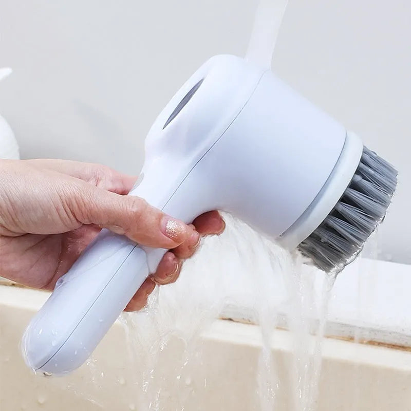 Light grey USB rechargeable electric cleaning brush with multiple interchangeable heads for kitchen use.