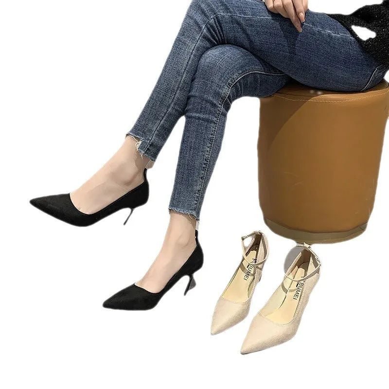 Women's black skull pattern stiletto heel pumps with buckle detail on rubber sole