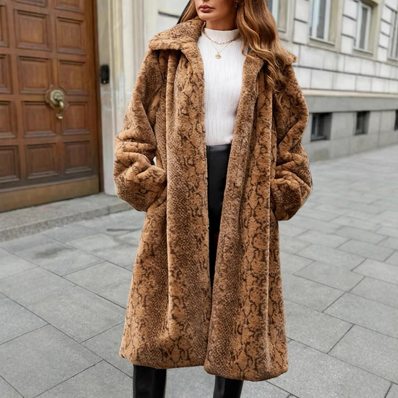 Women's long faux fur coat in leopard print, knee-length with regular sleeves.