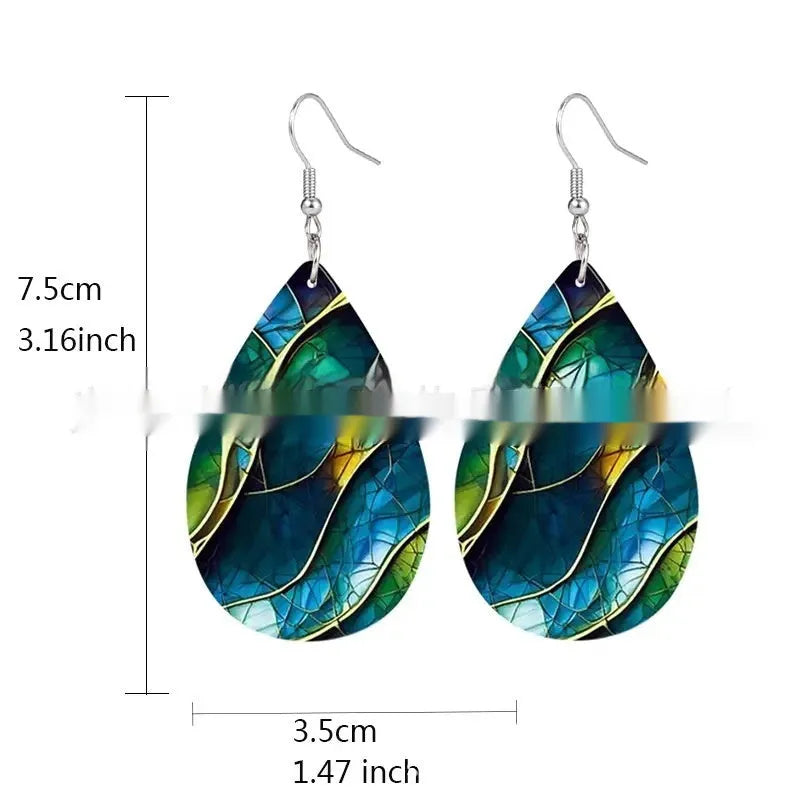 A pair of printed acrylic earrings with a flat branch knot design in a drop shape.