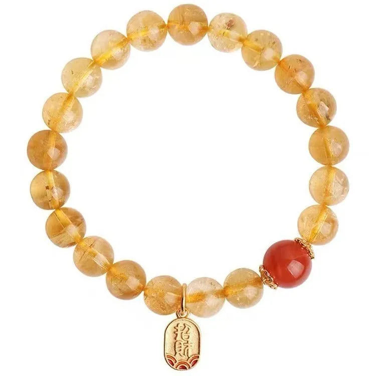 Natural red agate lucky beads bracelet with gold ruby accents on a wrist.