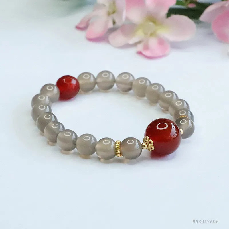 Women's smoky purple agate bracelet with 8mm geometric beads on a white background.