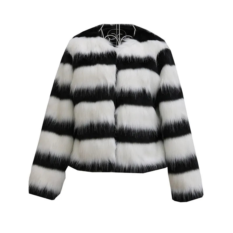 Women's long-sleeved black and white striped faux fur leather jacket on a hanger.