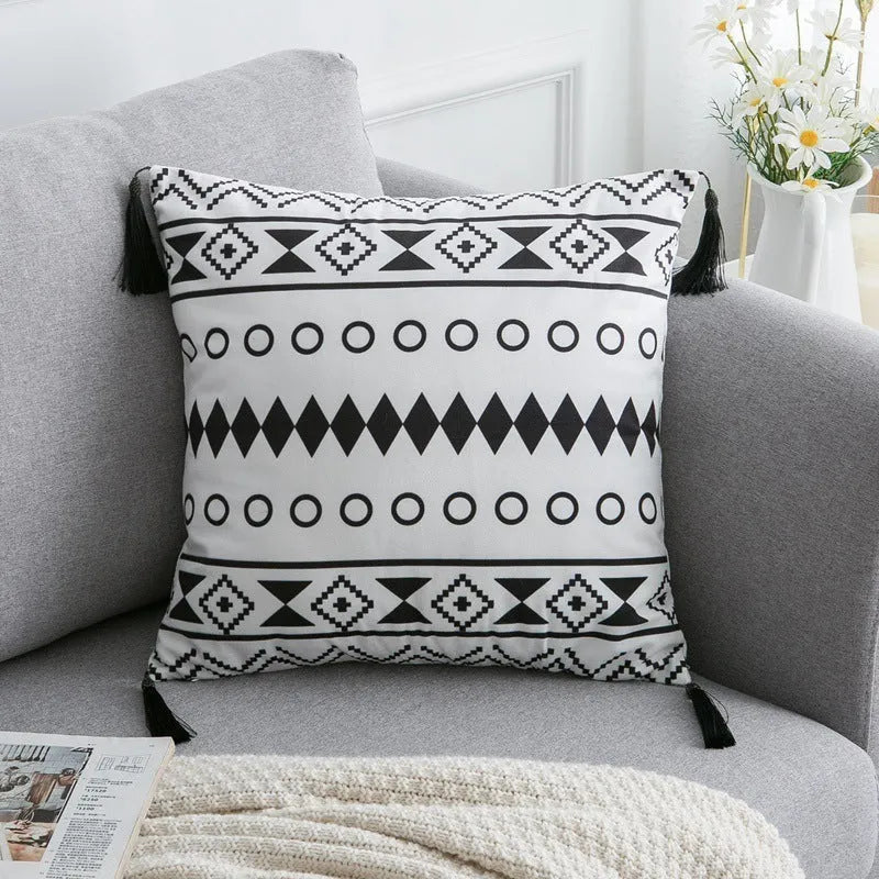 Bohemian national style polyester cushion cover in light grey on a sofa.