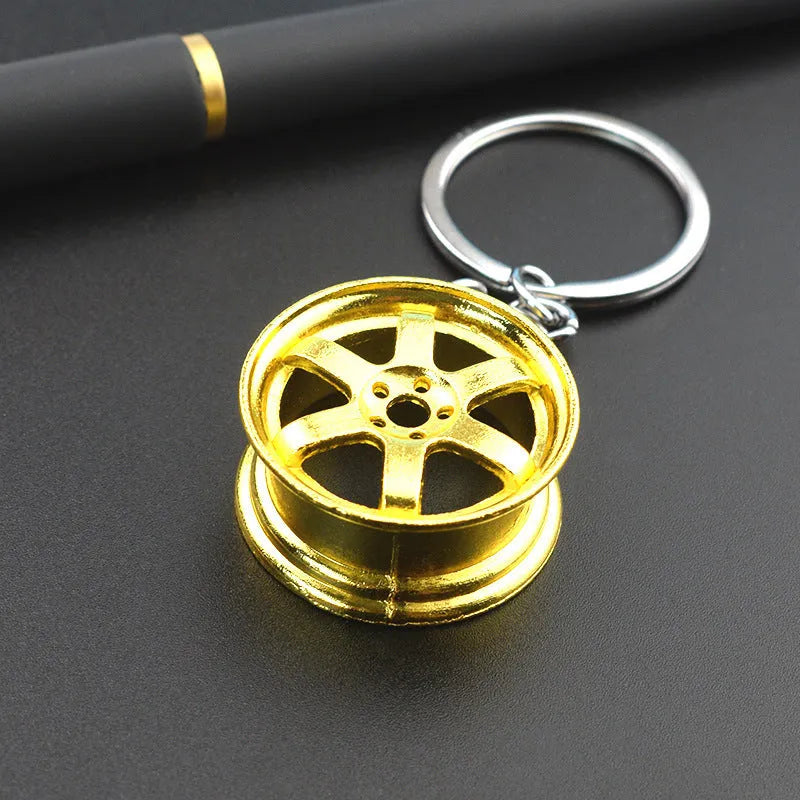 Stereo car wheel hub keychain in zinc alloy with gold, silver, and black colour options