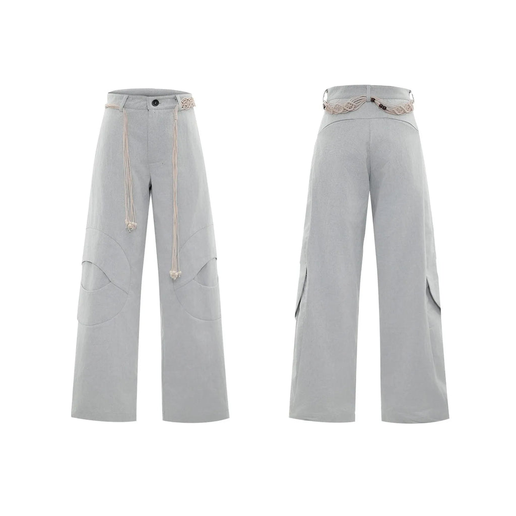 Men's dark blue straight-leg jeans with zipper decorations and tassel details on a loose cotton fit.