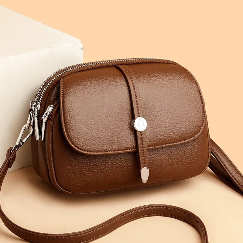 Women's soft PU crossbody shoulder bag with oval suitcase shape in black, khaki, or dark brown