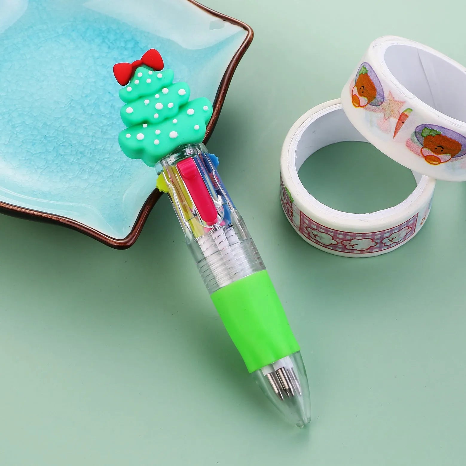 Compact 11cm Christmas ballpoint pen with four colours and festive designs like snowmen and reindeer.