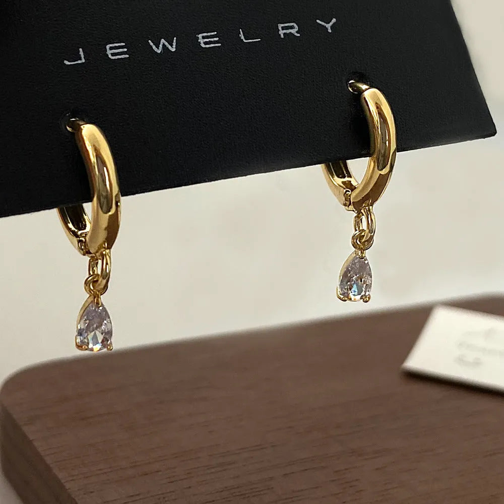 Women's zircon necklace, earrings, and anklet set with geometric pendant and meteor shower design.