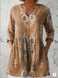 A loose-fitting women's dress with a wave print, 3/4 sleeves, and a wide waist.