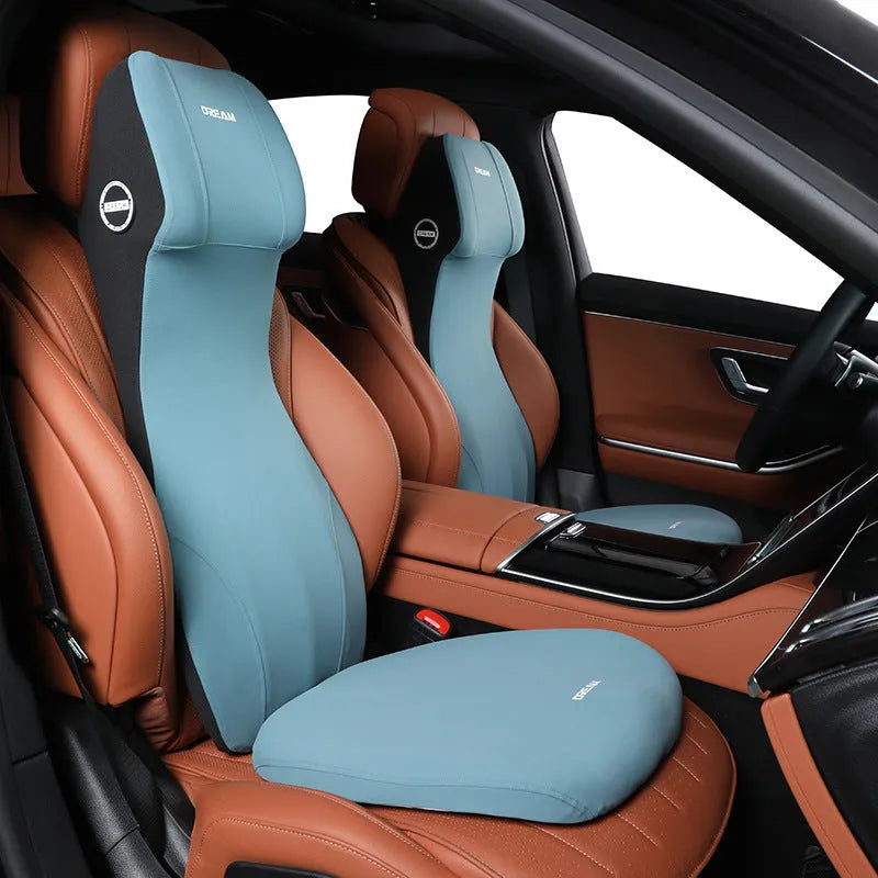 Black automotive memory foam waist cushion and headrest pillow set on a car seat.