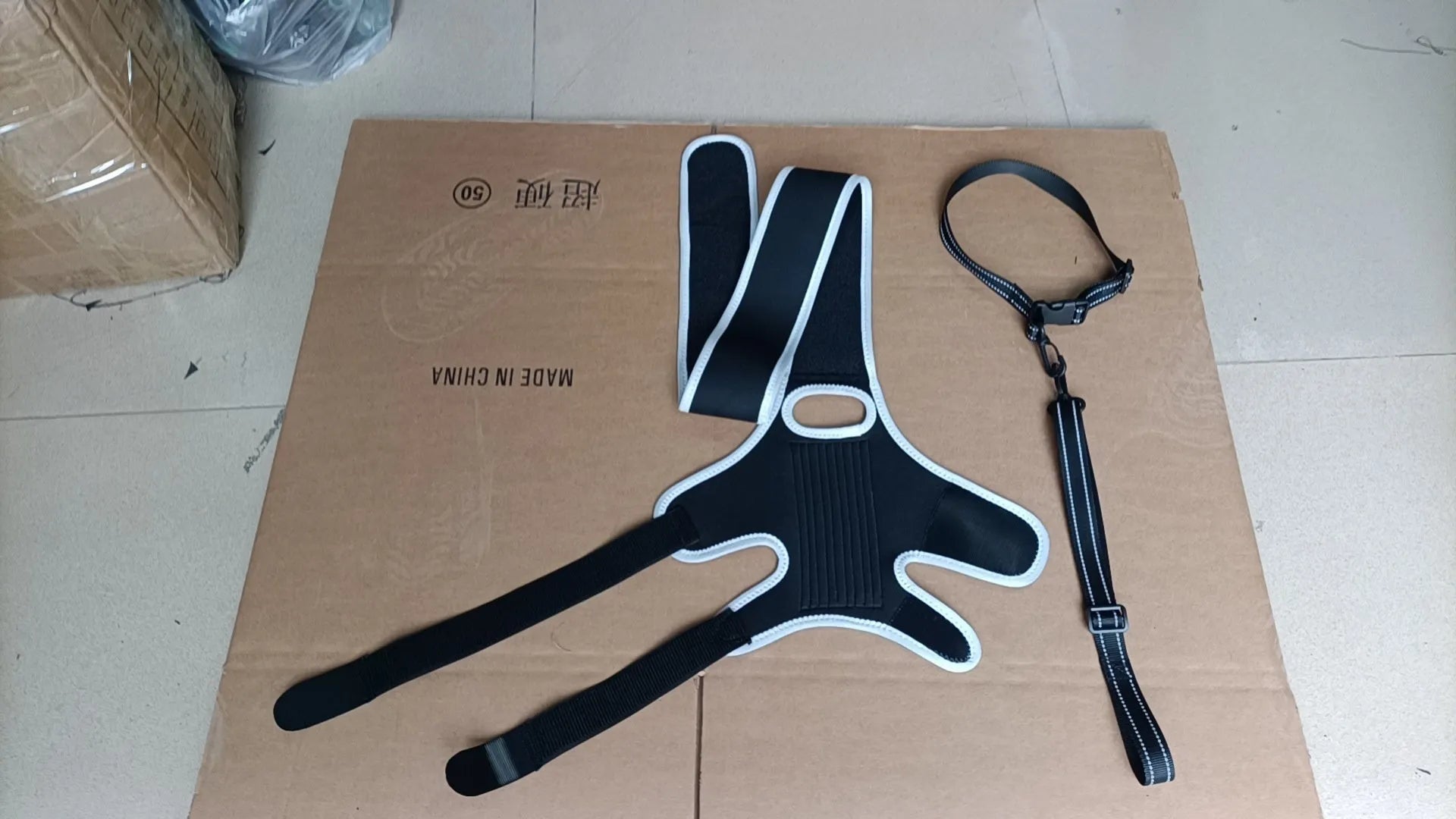 Neoprene dog hind leg knee brace assist strap shown in collar black colour, sized for medium dog.