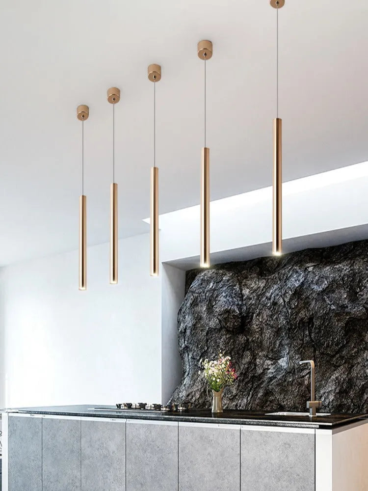 French gold long cylindrical iron chandelier with PMMA lampshade on simple modern background